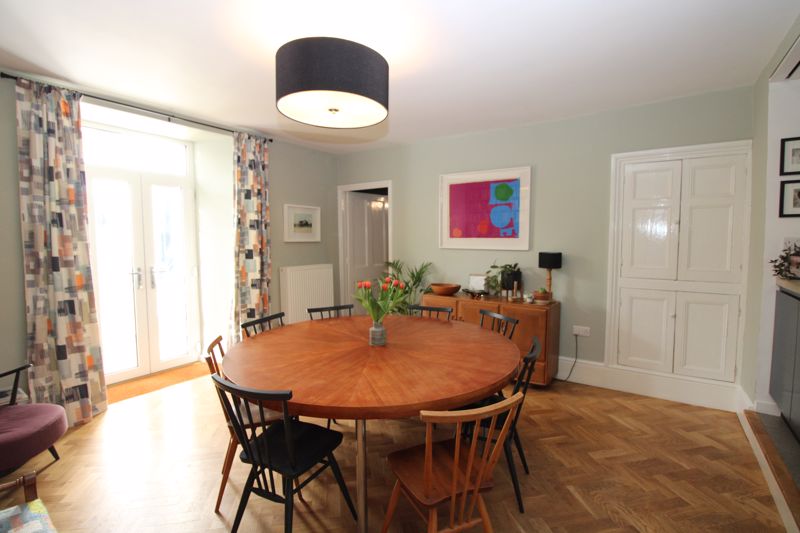 Dining room with herringbone style wood floor